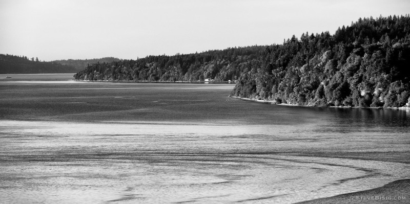 A black and white fine art landscape photograph of the South end of Vashon Island and the Puget Sound as viewed from the Point Defiance Park in Tacoma, Washington.