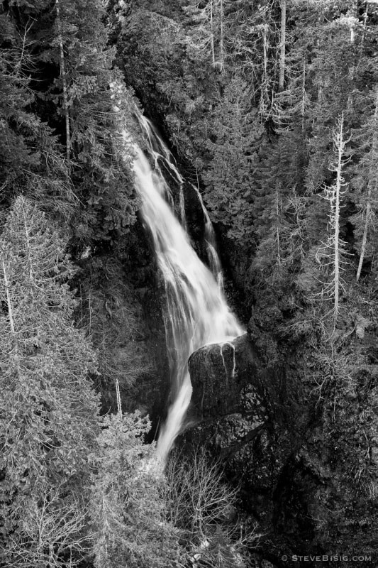 A black and white fine art landscape photograph of Vincent Creek Falls as viewed from the High Steel Bridge, 365 feet (or 420 feet depending upon the source) above the South Fork of the Skokomish River in rural Mason County, Washington.