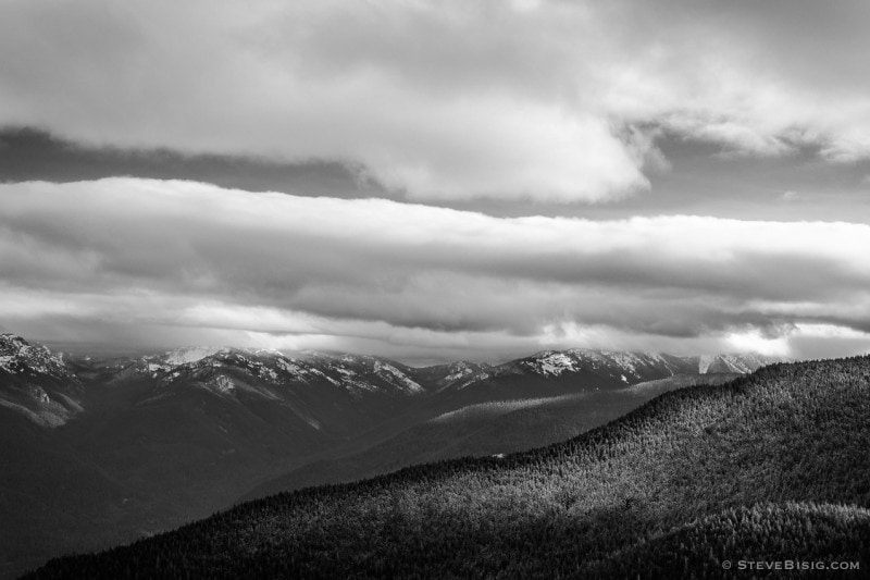 A black and white photograph looking towards the Washington Cascades on a cloudy late Autumn day as seen from the Sun Top Lookout near Mount Rainier National Park, Washington.